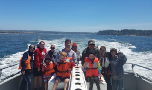 a group of people standing next to a body of water