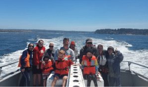 a group of people standing next to a body of water