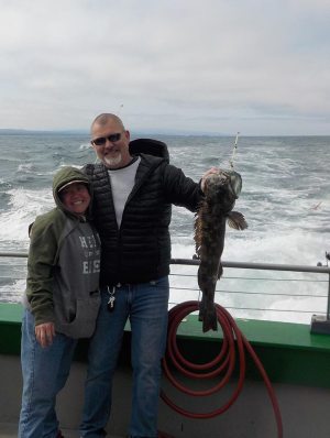 a man and a woman standing next to a body of water