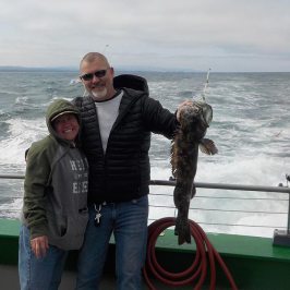 a man and a woman standing next to a body of water