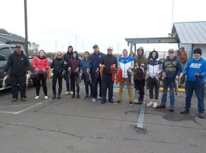 a group of people standing on a sidewalk